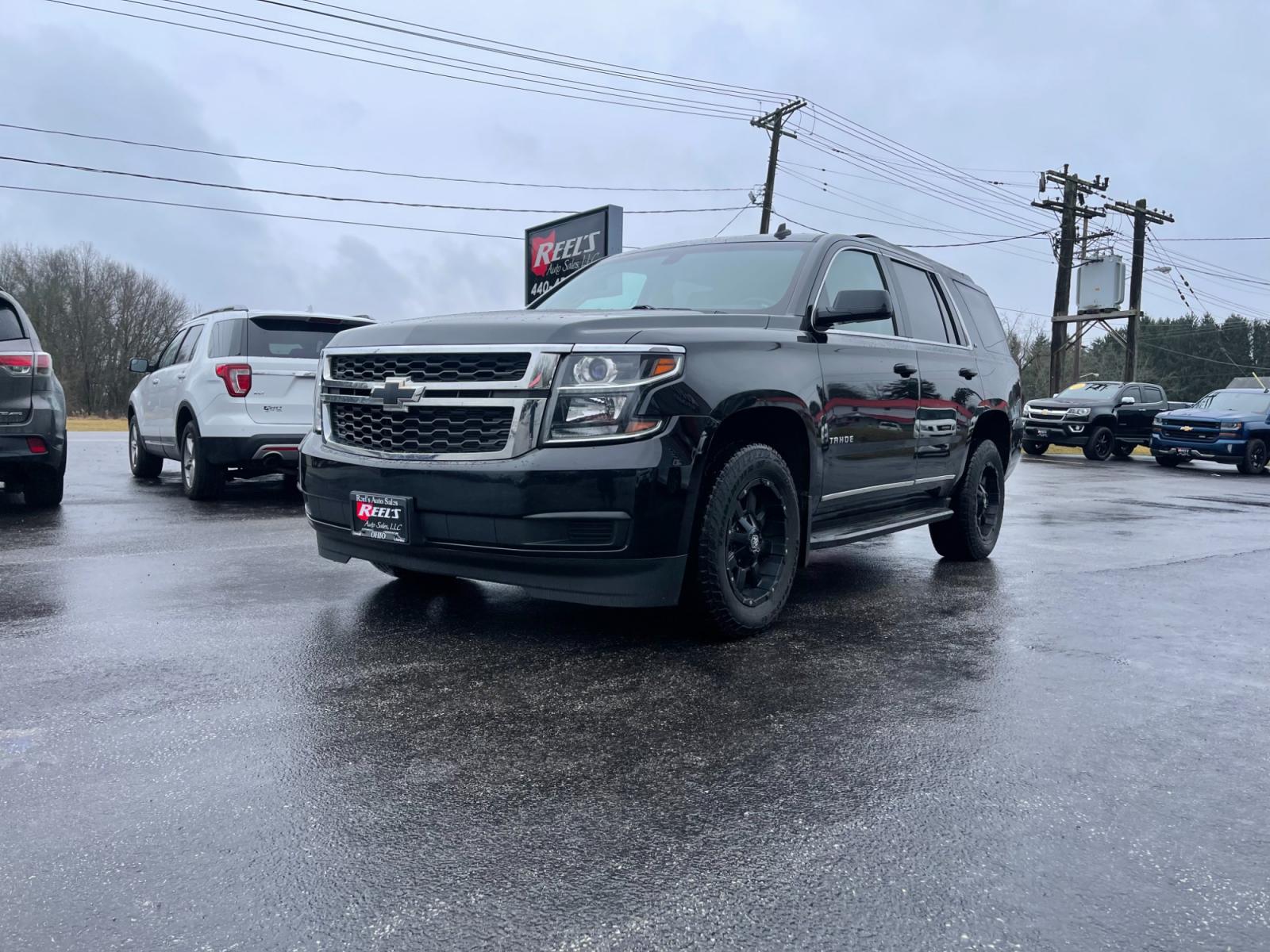 2015 Black /Black Chevrolet Tahoe LS 4WD (1GNSKAEC8FR) with an 5.3L V8 OHV 16V engine, 6-Speed Automatic transmission, located at 547 E. Main St., Orwell, OH, 44076, (440) 437-5893, 41.535435, -80.847855 - This 2015 Chevrolet Tahoe LS 4WD is a versatile and robust full-size SUV that offers a range of comfort and utility features, appealing to families and those needing a capable vehicle for towing and outdoor adventures. Equipped with Tri-Zone Automatic Climate Control, Power Front Seats, and Rain Sen - Photo #0